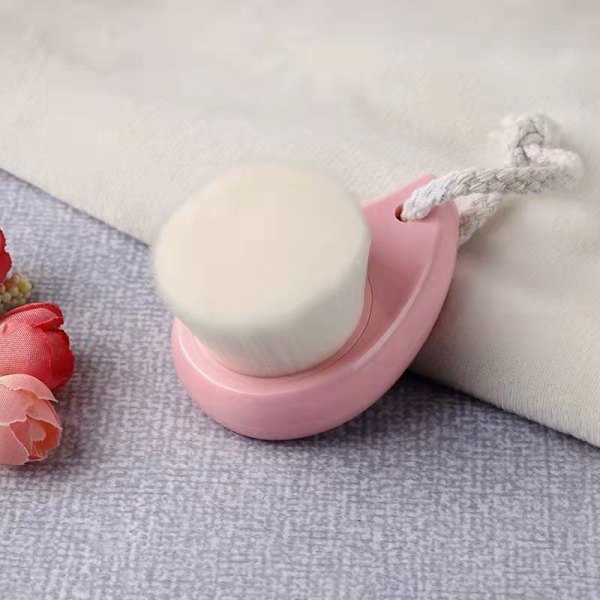 Ansiktsrengöringsverktyg med en mjuk rosa färg