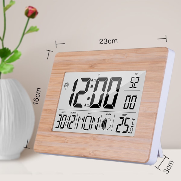 Radiostyrd digital klocka med DCF-tidssignal, hölje med äkta bambu, LCD-display, termometer, väckarklocka och kalender. Batteri ingår