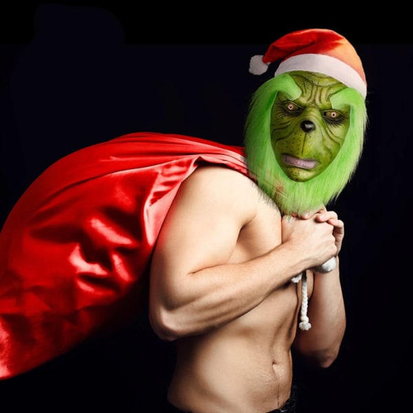 Grinchen, julmonstret, spelar rollen som kostym, och det grönhåriga monstret är uppklädd överallt