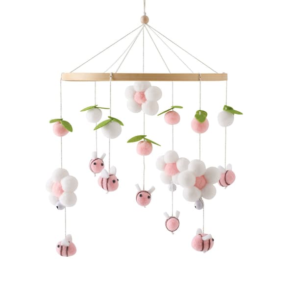 Træuro til drengebørn, med pomponer, blomster og bi-formede ornamenter.