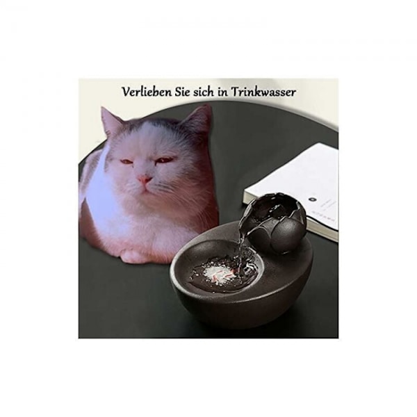 Musta keraaminen vesilähde pystysuoralla lootuksella ja automaattisella syötöllä