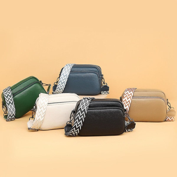 Pieni nahkainen crossbody-laukku, jossa leveä vetoketju ja irrotettava olkahihna, musta