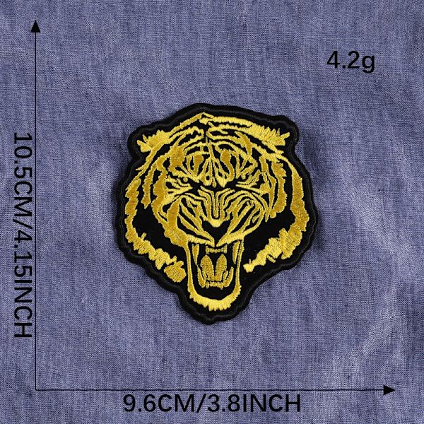 Broderad lapp i form av en gyllene tiger, att sy eller att st