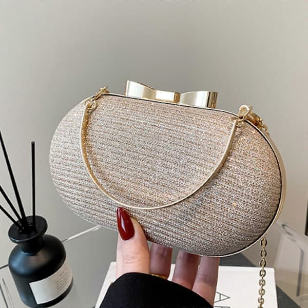 Oval Glitter Aftenclutch med Topphåndtak og Kjedestropp, Gull