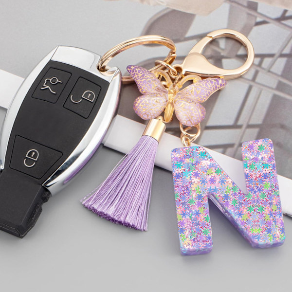 Sööt roosad võtmehoidjad naistele ja tüdrukutele, algustähega võtmehoidjad tutiga, ripatsid võtmetele, rahakotile, käekottidele ja seljakottidele Purple Butterfly Letter-n