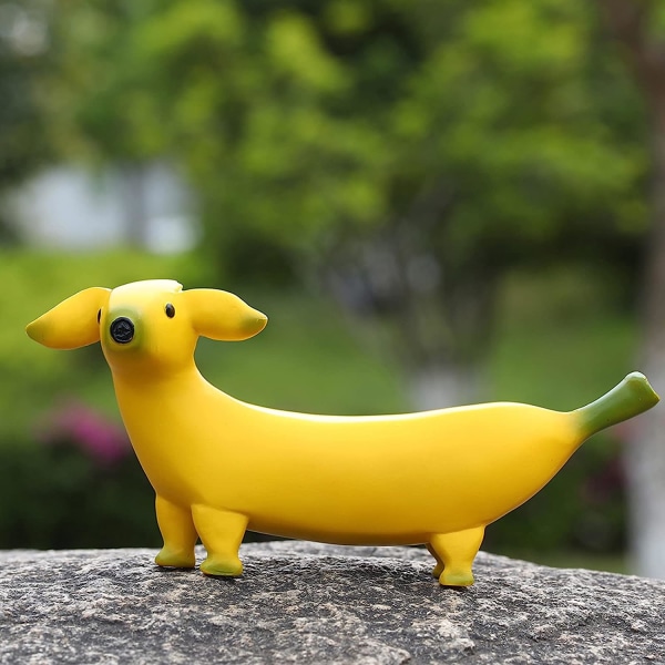 Søt banan hund hage statue ornament, kreativ harpiks hage dverg