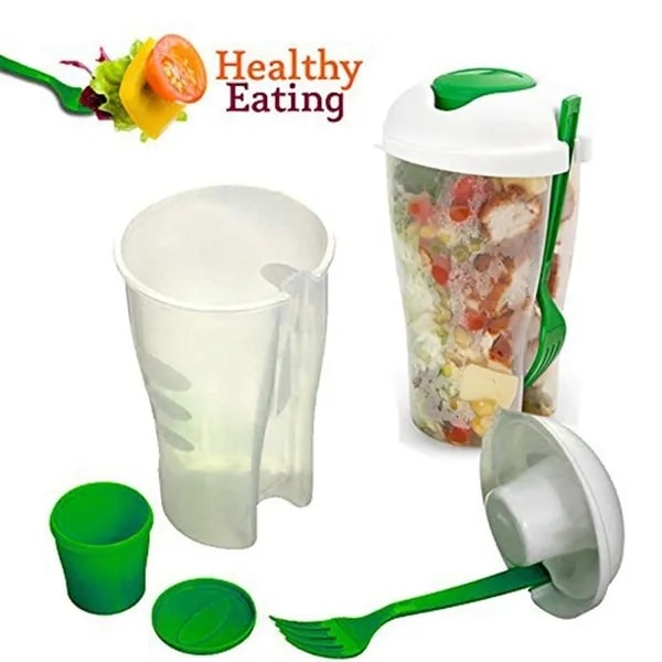 Salatkopp med gaffel og dressingbeholder