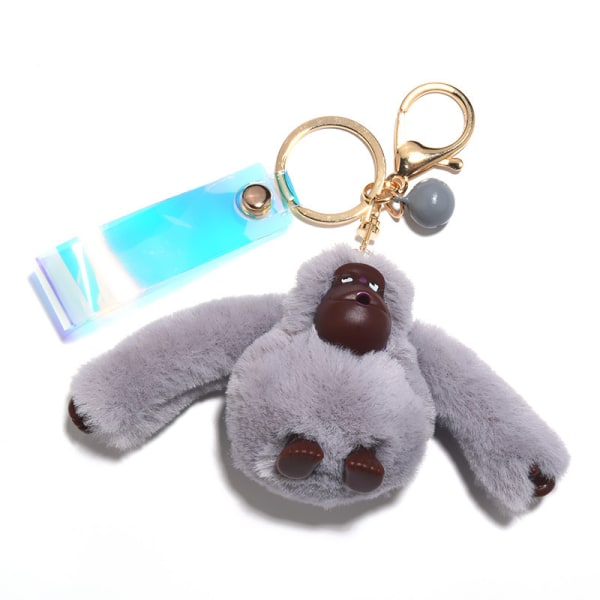 Vaaleanharmaa luova söpö gorilla-pehmoleluavainperä