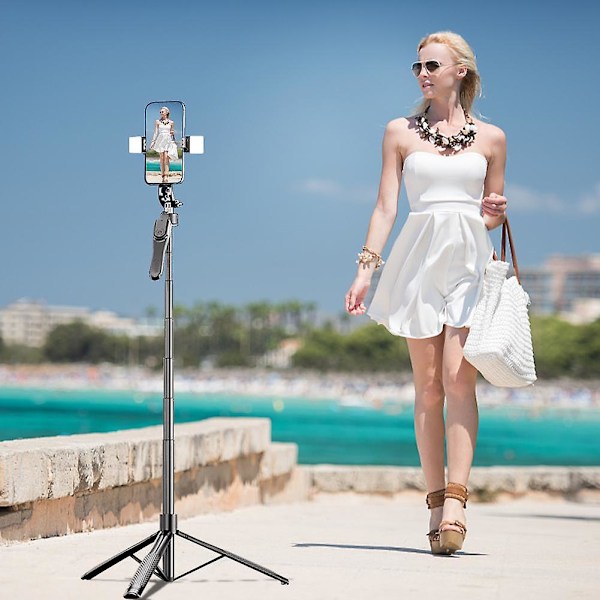 Langaton kauko-ohjattava selfiekeppi puhelinteline 2.1M jatkettava jalustateline A lamp and a shelf