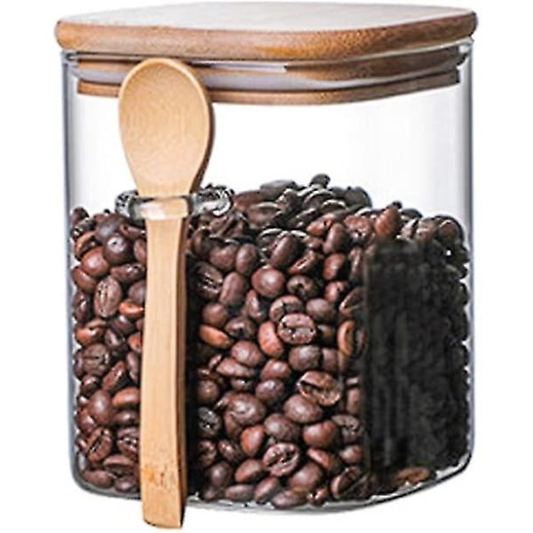 Fyrkantig lufttät förvaringsburk av glas med träsked kaffeböna