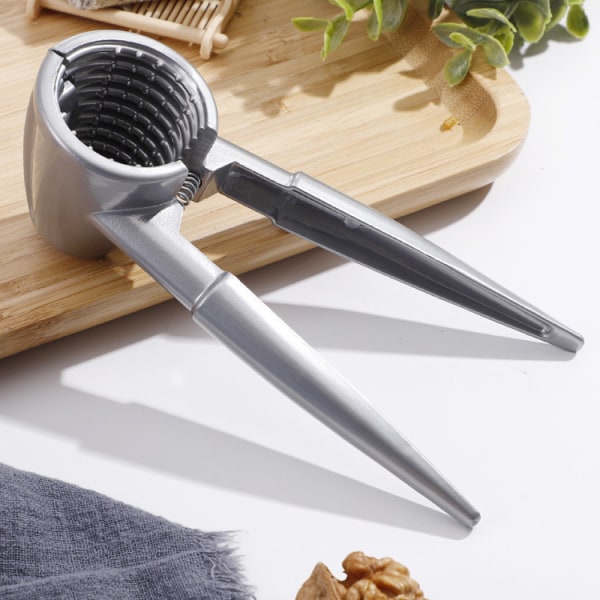 En silverfärgad aluminiumlegering valnötsklippa hushålls hickory skål
