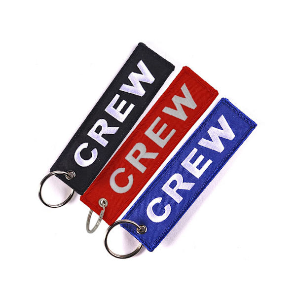 CREW-tietokoneen ompelun avaimenperä, jossa valkoiset merkit
