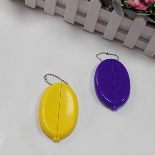 Pieni soikea kolikkokukkaro, jossa säilytetään kolikoita, minikolikkokukkaro, kolikkotelineet ketjulla miehille ja naisille Yellow
