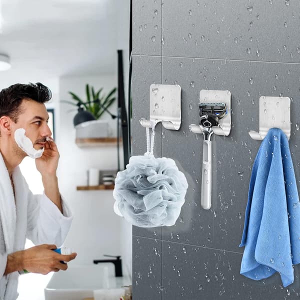 Wall-mounted shower caddy with hooks for razors and towels