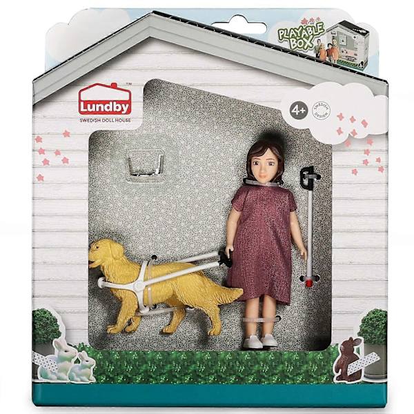 Dockdocka med vit käpp och ledarhund
