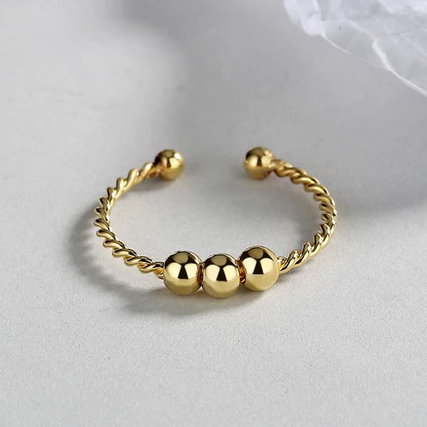 Justerbar antistressring med roterbare perler Gull