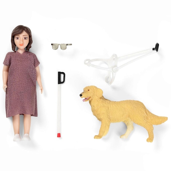 Dockdocka med vit käpp och ledarhund
