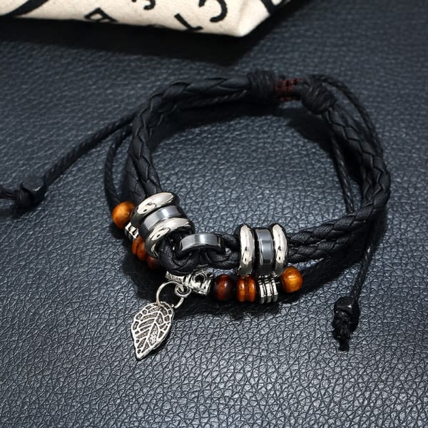 Svart kreativt läderarmband med flätade bladberlocker