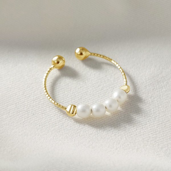 Justerbar anti-stress ring med drejelige perler Guld