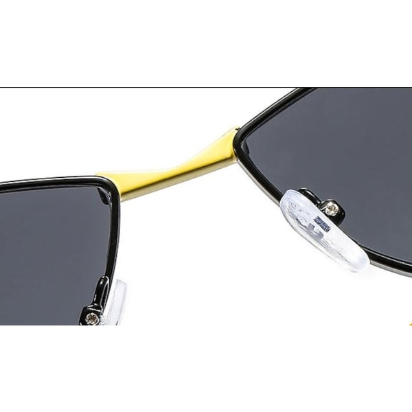 Minimalistiska svarta solglasögon med gulddetalj cat-eye Svart one size