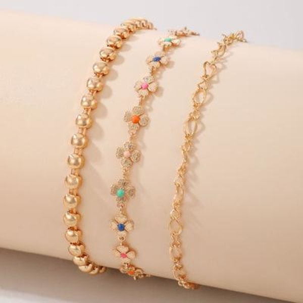 Set á 3 stk rhodiumpläterade armband med blommor i olika färger Guld one size
