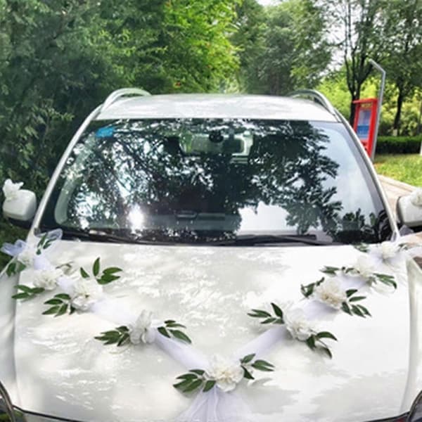 Bröllopsbilsblomsterplatta med bandrosetter och dörrdekoration