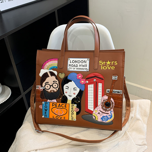 Niche-muotoilun rajat ylittävä naisten laukku, uusi tilkkukirjailtu työmatkalaukku, eurooppalainen ja amerikkalainen retro-olkalaukku, messenger-kassi Yellow-brown