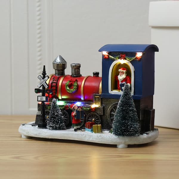 Lysende nissefigur i juletog av harpiks