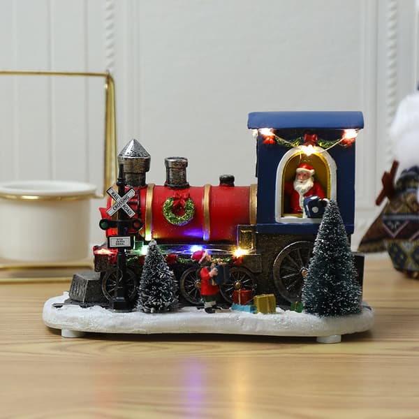 Lysende nissefigur i juletog av harpiks