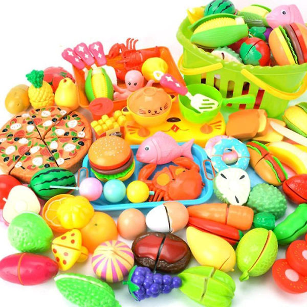 Barn skär frukt och grönsaker låtsas leka med set