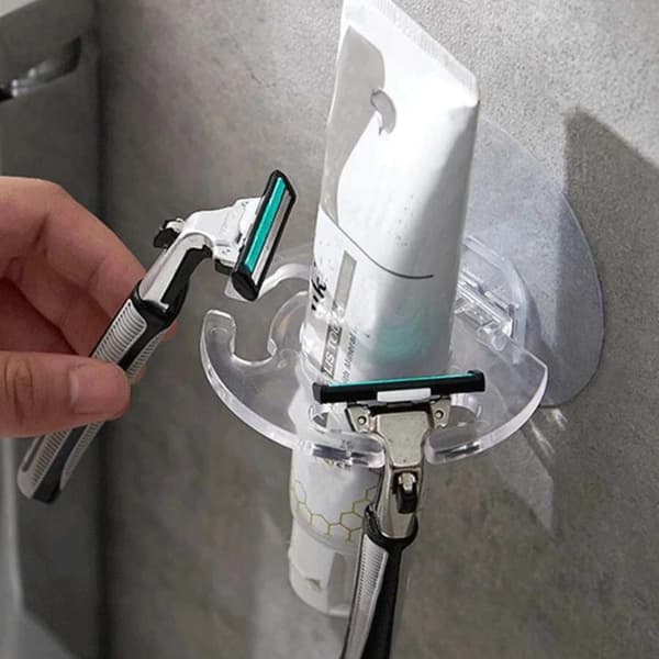 Wall-mounted toothbrush holder with suction cups and toothpaste storage, suitable for the bathroom.