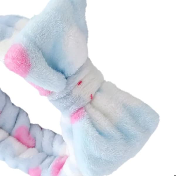 Fleece-hiuspanta, jossa on siniset pupumallit Blå