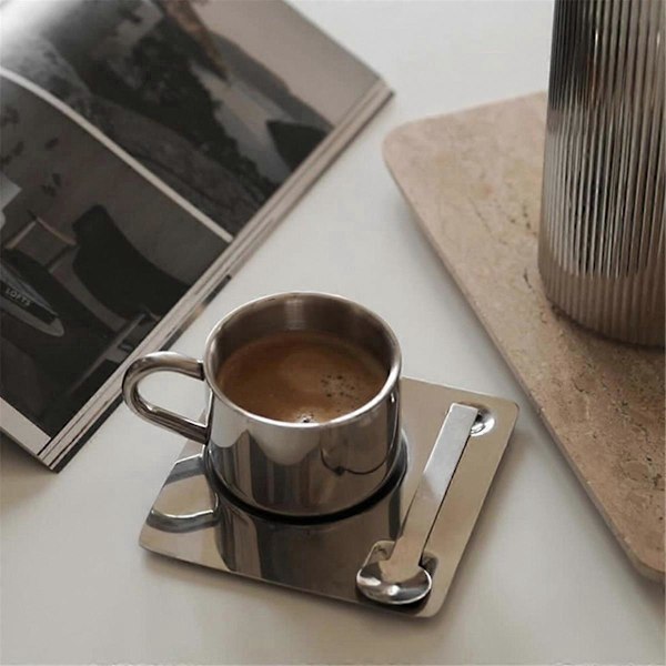 Kaffekoppset med sked, bordstablett, vattenkopp, bordsartiklar, som visat