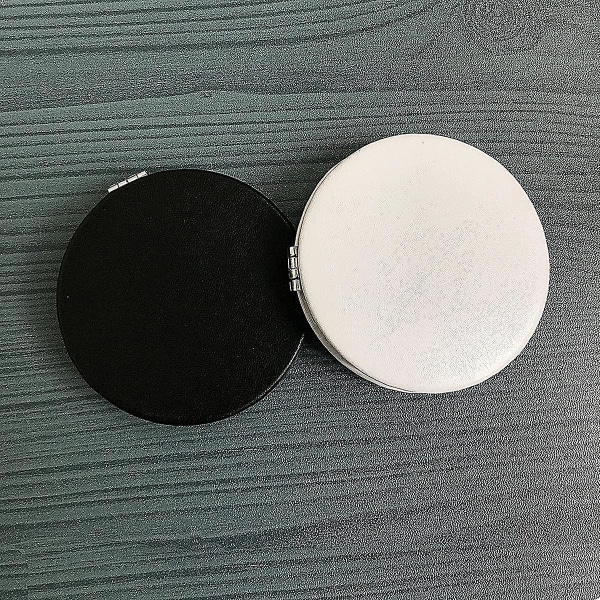Musta ammattimainen kaksipuolinen taitettava pyöreä meikkipeili, jonka halkaisija on 7,7 cm