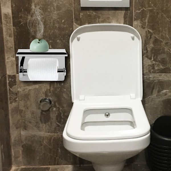 Ruostumattomasta teräksestä valmistettu seinälle kiinnitettävä WC-paperiteline, jossa on matkapuhelimen säilytyshylly